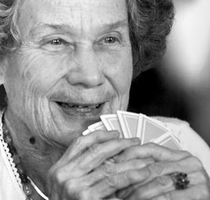 Harriet Rasor McCarthy, holding cards and smiling