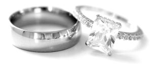 a man's ring on the left, a woman's ring with large diamond on the right