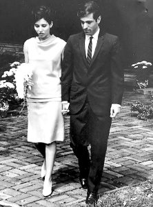 Author Julie Oktay, left, holding a bouquet, with husband her on their wedding day.