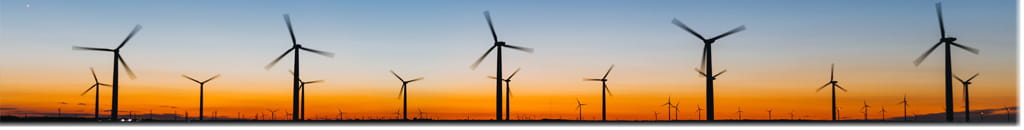Silhouette of a wind farm on a landscape.