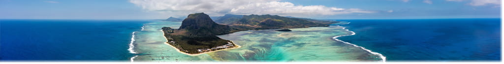 Overhead view of a mountain in the middle of a large body of water.