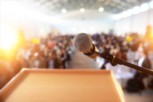 Microphone above a podium, facing an audience