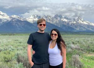 Jasmine and Paul Hartmeier standing in front of a mountain range.