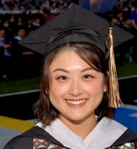 JHU AAP Graduate Sakura Chen wearing a cap and gown on graduation day.