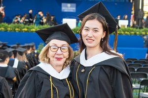 Myrna Blyth (left) and Kaylee May Law (right) in caps and gowns at the 2025 KSAS graduation ceremony