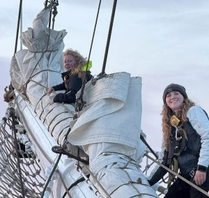 Two students working on the sail