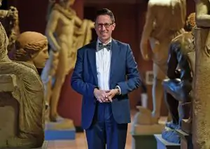 Alumni Ambassador standing in a Museum collection of ancient statues