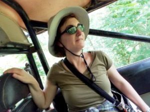 Elena Mastors in a jeep, wearing a hat and sunglasses.