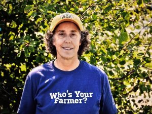 Linda Kiltz wearing a blue sweatshirt that says "Who's Your Farmer?"
