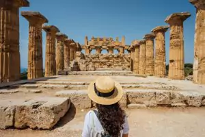 Person standing in front of historic ruins in the desert